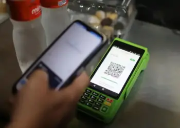 Pessoa faz pagamento por PIX com celular